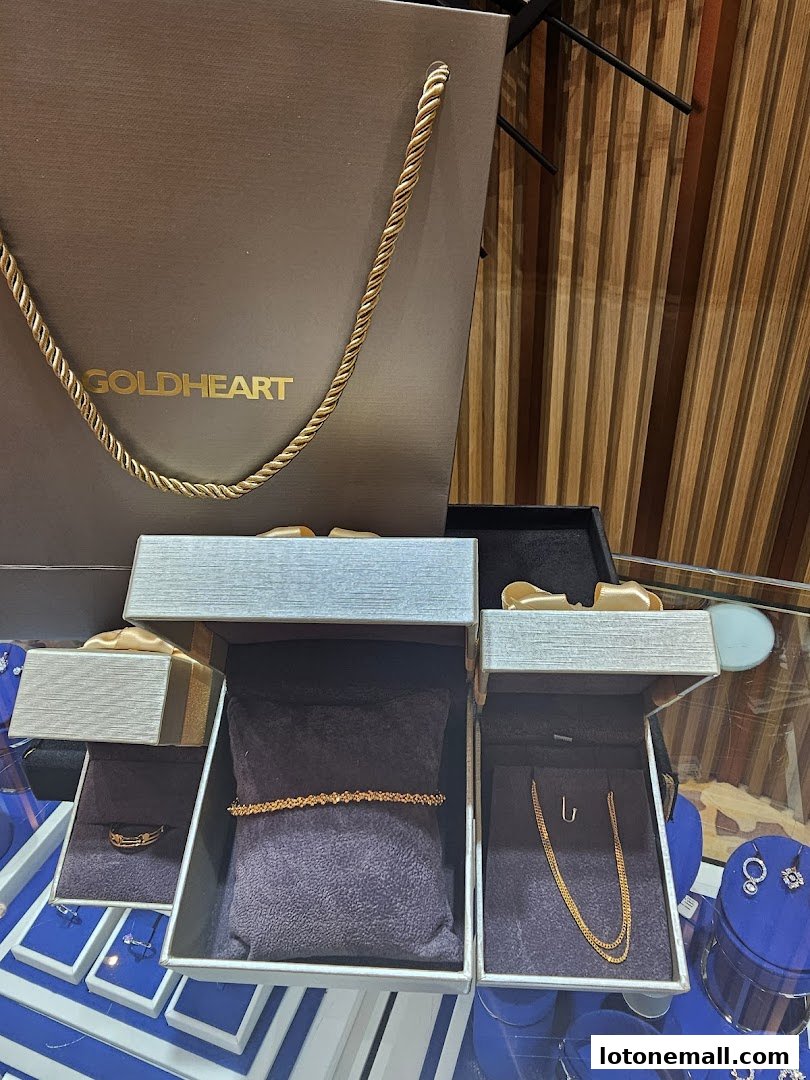 Goldheart Jewelry display featuring rings, bracelets, and necklaces in elegant boxes.