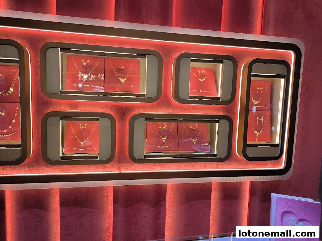 A display of elegant gold necklaces and earrings in illuminated showcases.