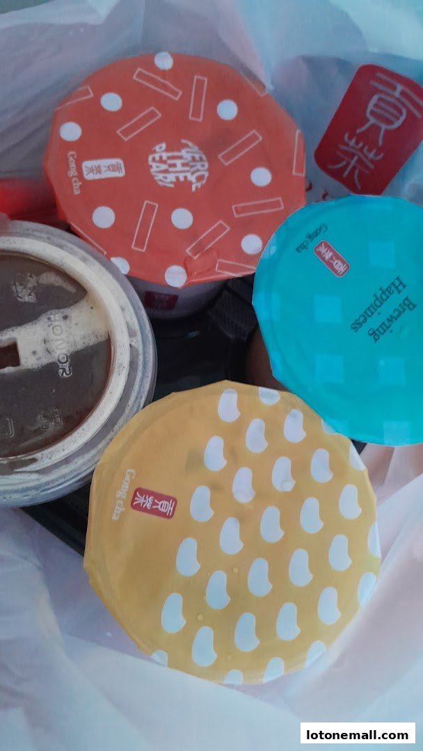 A collection of colorful bubble tea drinks from Gong Cha in a plastic bag.