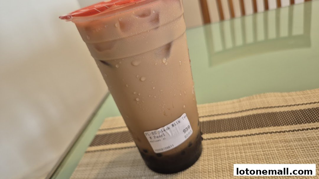 A close-up of a refreshing Gong Cha Black Milk Tea with pearls.