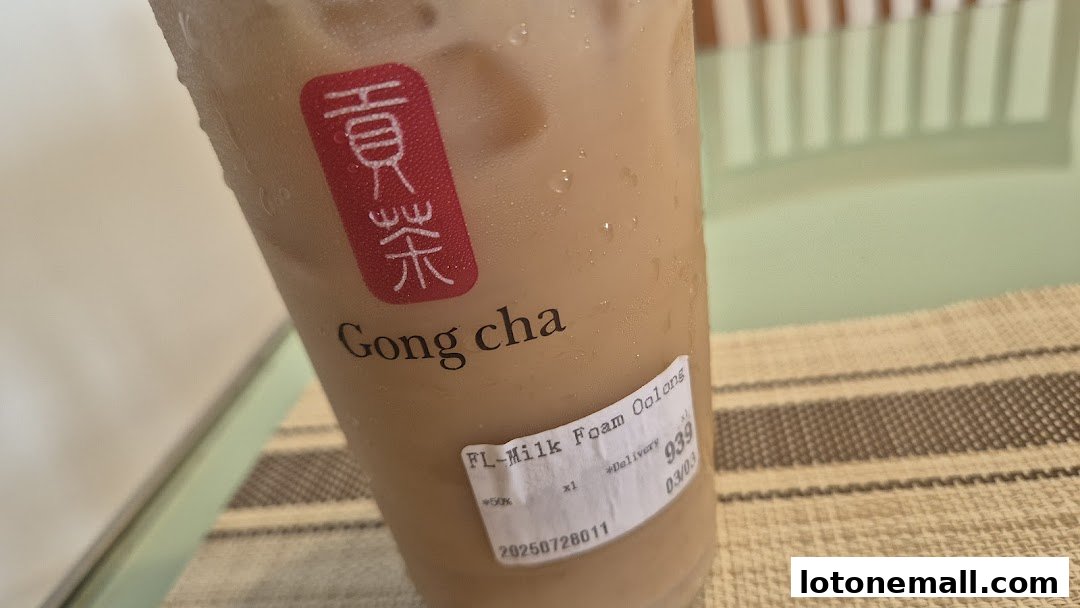 A close-up of a Gong Cha milk tea with a label showing the drink and order details.