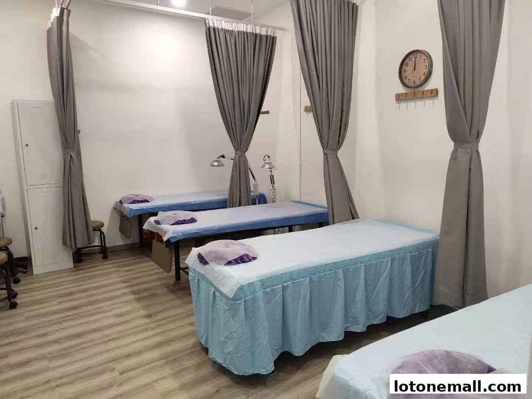Interior of a TCM clinic with multiple treatment beds and privacy curtains.