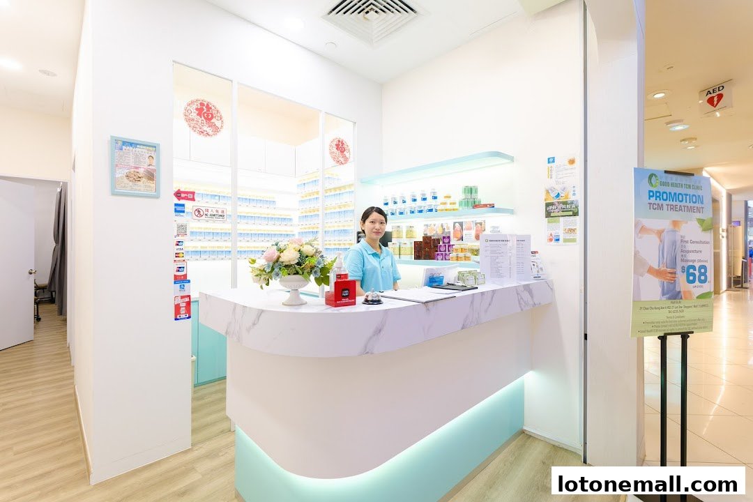 A woman stands behind the counter of a clean and modern TCM clinic, with shelves of products in the background.