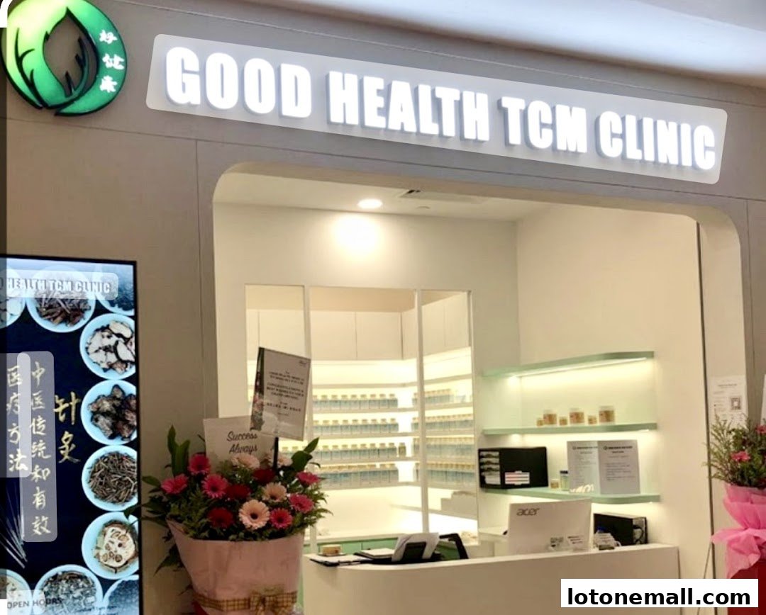 The entrance of Good Health TCM Clinic, featuring a bright sign, display of herbs, and a reception counter.