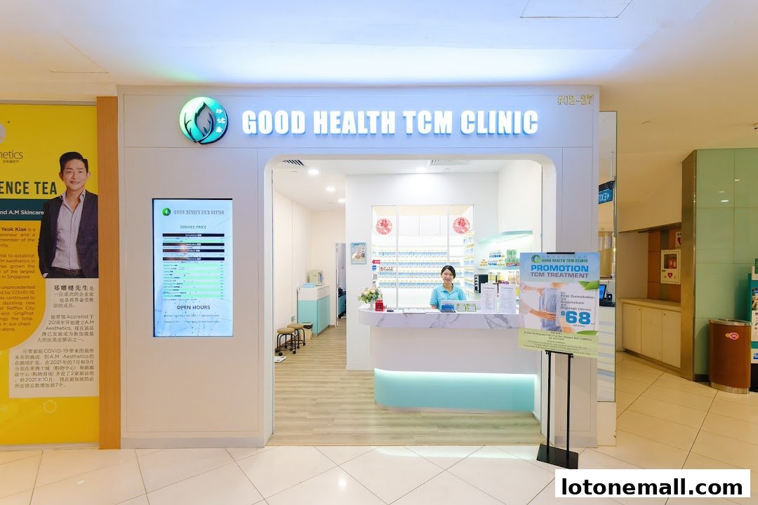 The entrance of Good Health TCM Clinic with a reception desk, staff, and promotional materials.