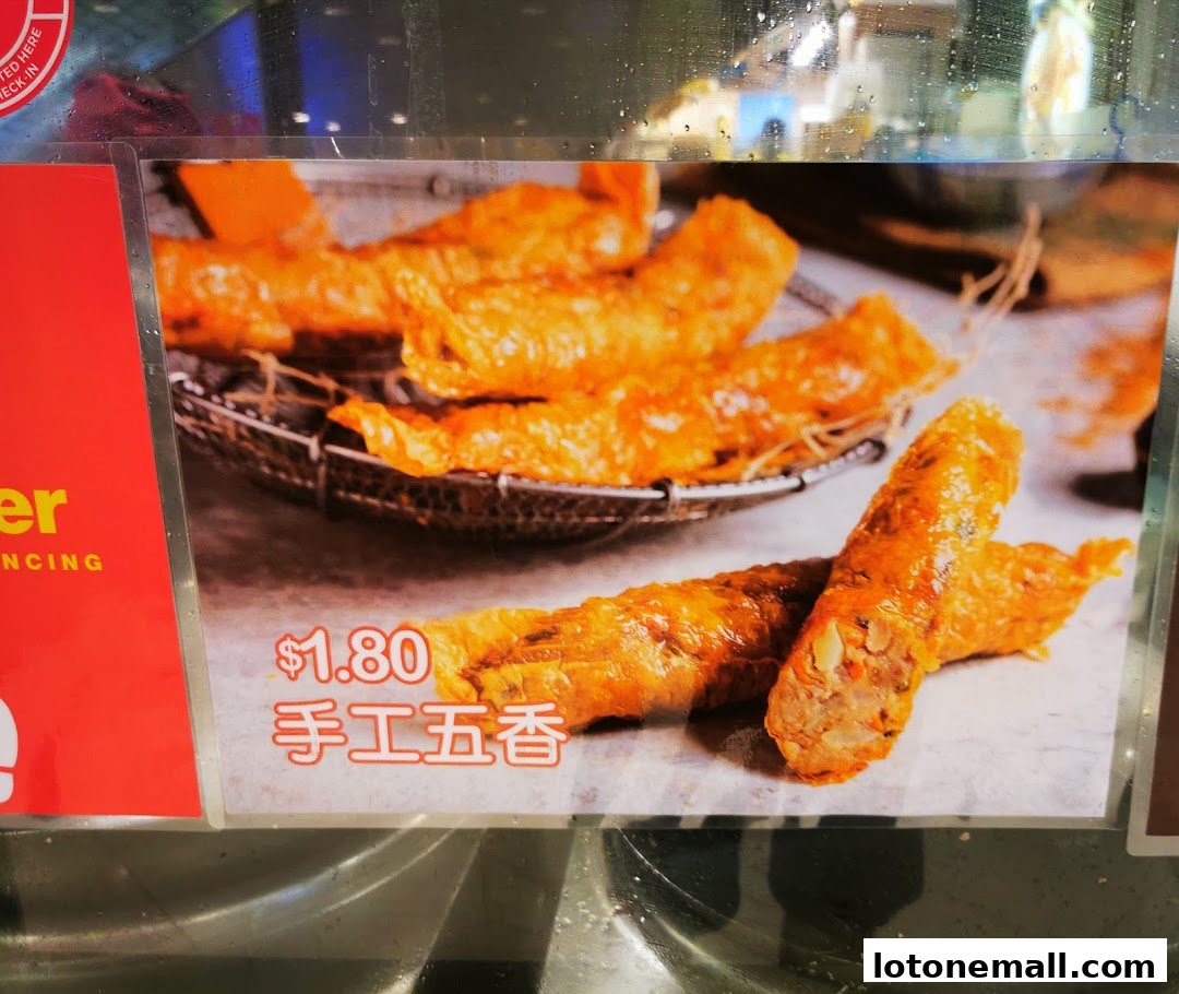 A close-up image of crispy fried spring rolls with a price tag and Chinese characters.