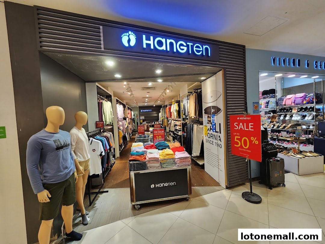 The entrance of a Hang Ten clothing store with mannequins and a sale sign.