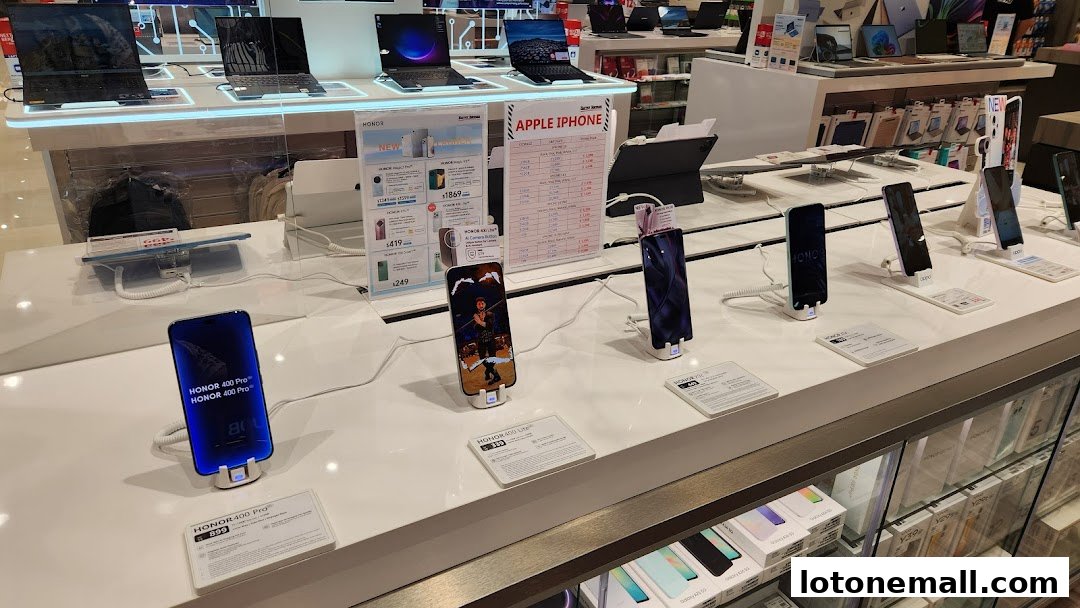 Display of various smartphones and laptops at Harvey Norman Lot One.