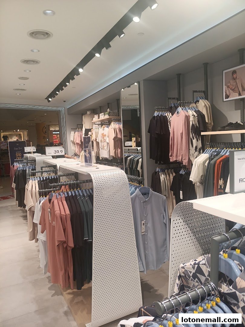 Interior view of a clothing store with racks of apparel and a price tag visible.