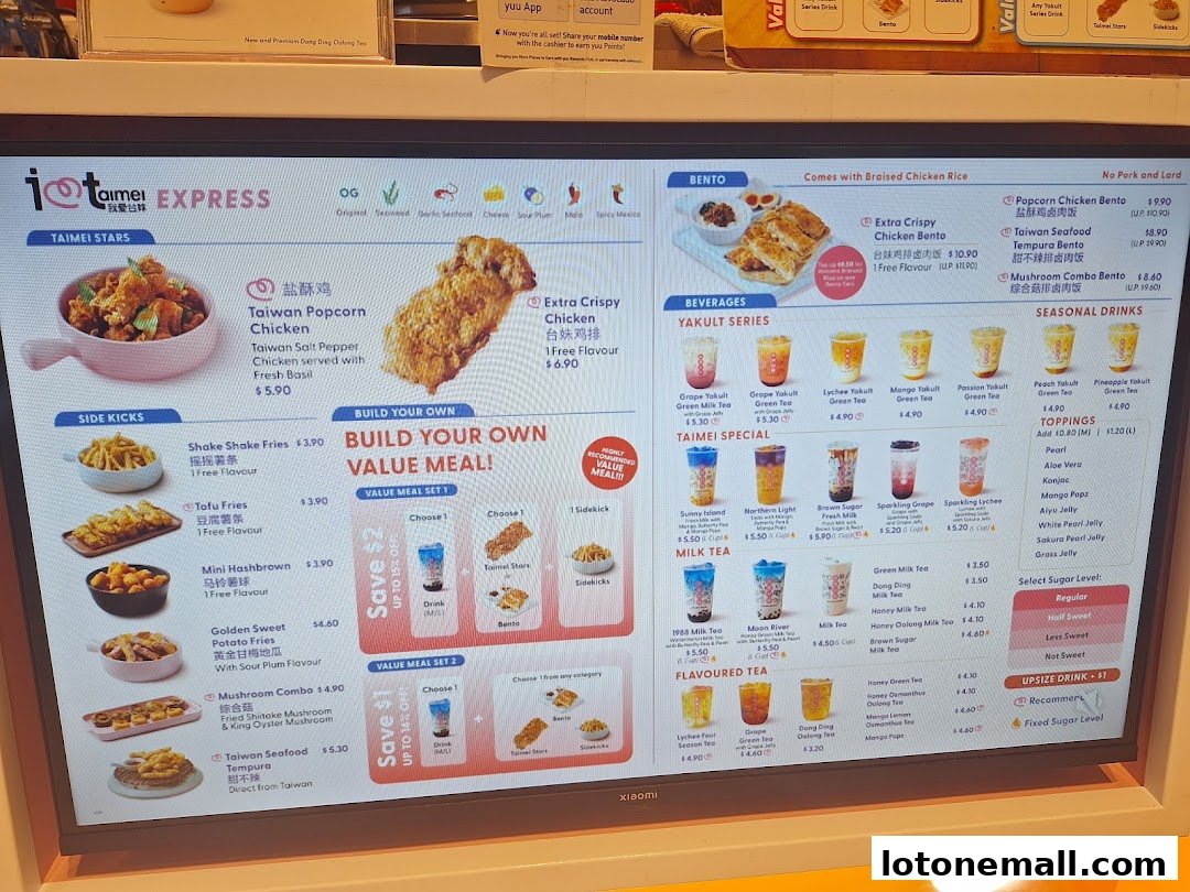 A digital menu board displaying various Taiwanese fried chicken, bento boxes, milk teas, and seasonal drinks.