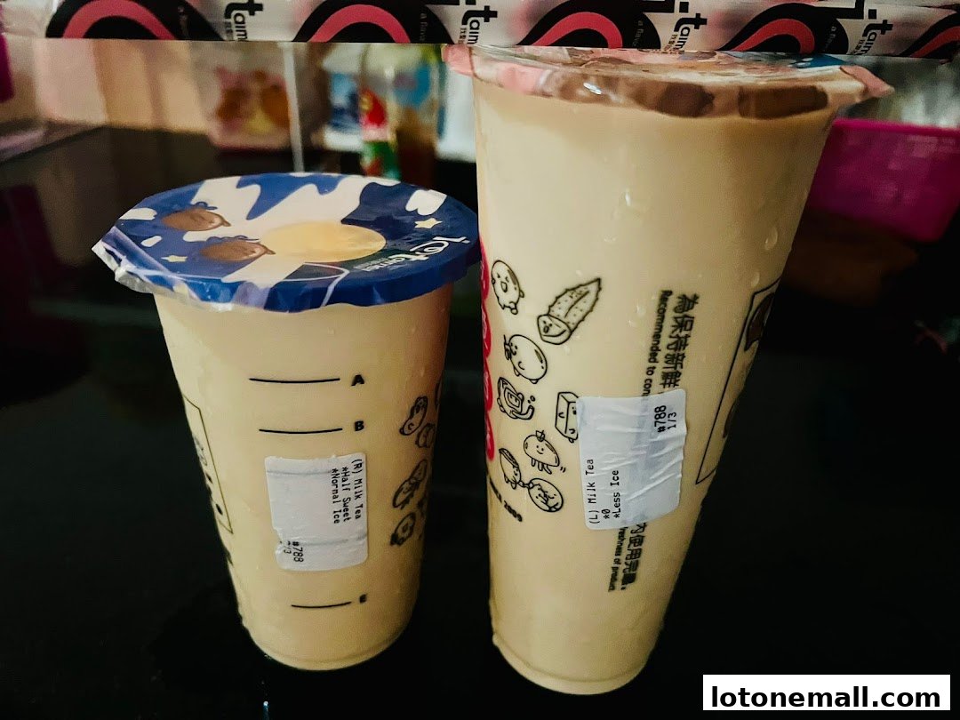 Two cups of milk tea with cute cartoon characters and branding from 'I Love Taimei'.