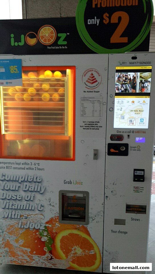 A vending machine dispensing freshly squeezed orange juice, with a promotion for $2.