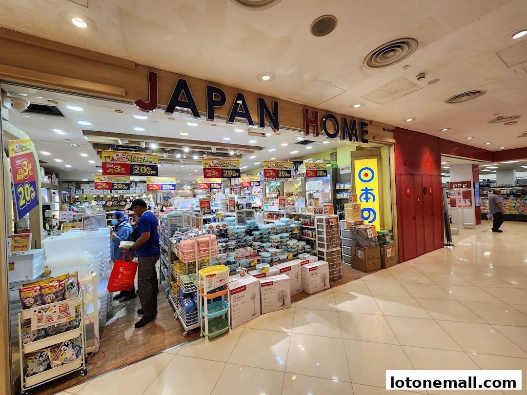 The entrance of a Japan Home store, showcasing various household items and promotional signs.