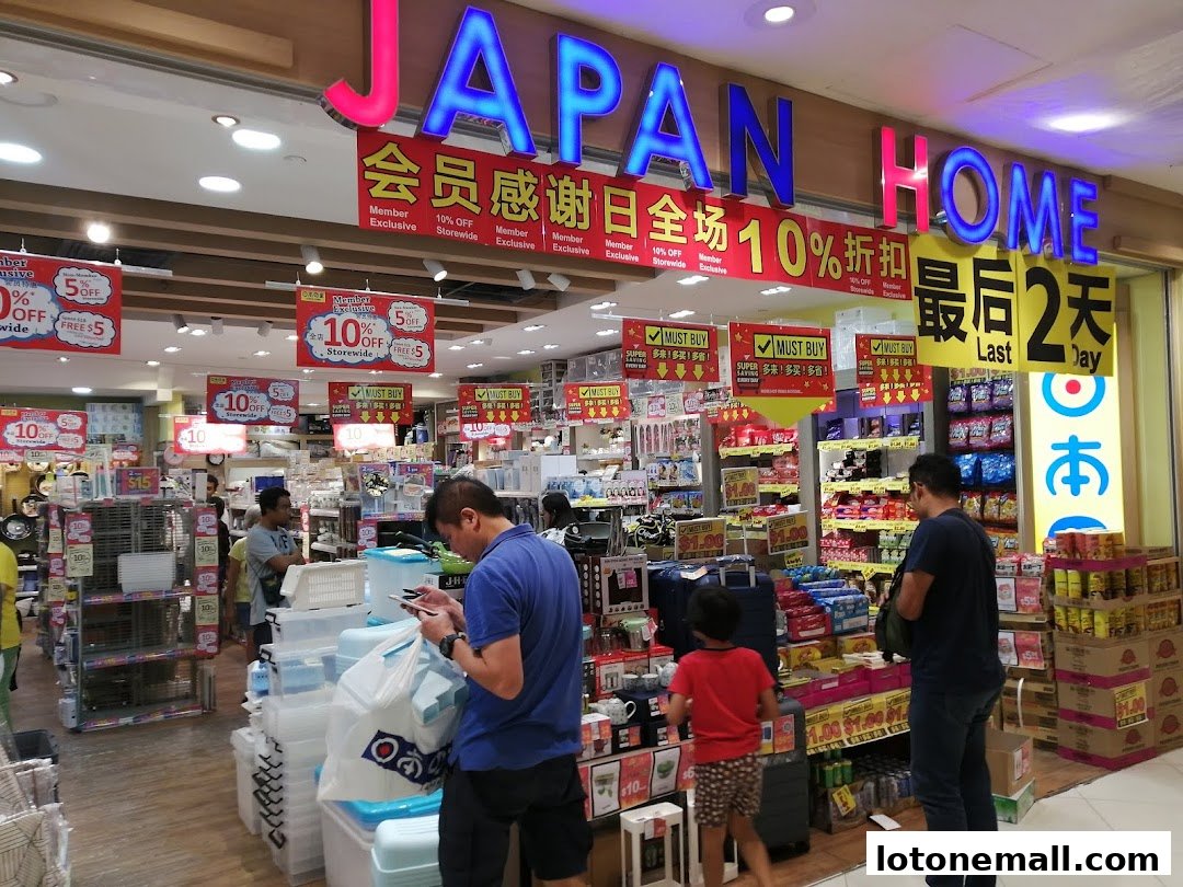 The entrance of a Japan Home store with promotional signs and shoppers.
