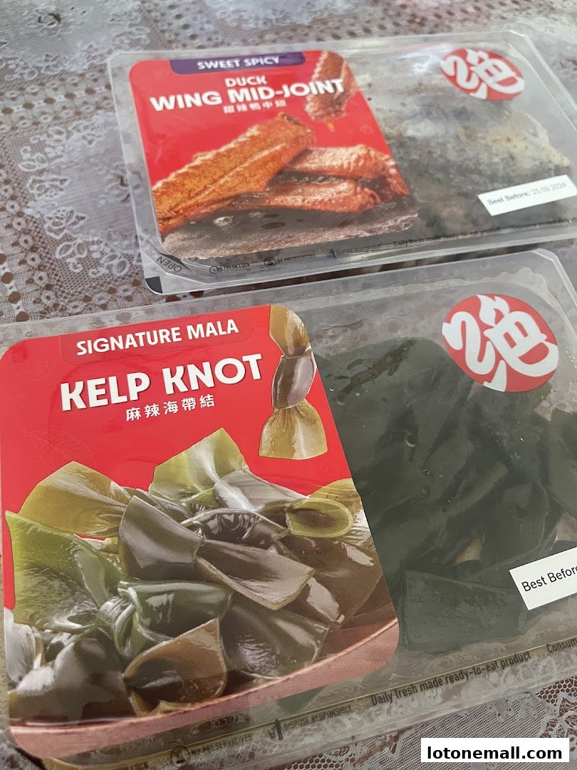 Two pre-packaged ready-to-eat food items: duck wing mid-joint and kelp knot.