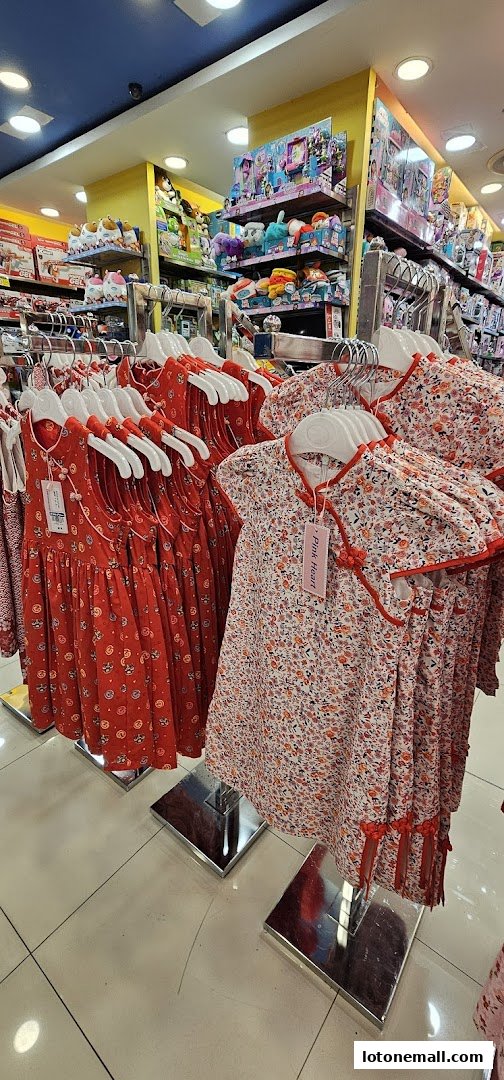 Kiddy Palace shop interior displaying racks of children's dresses and shelves stocked with toys.