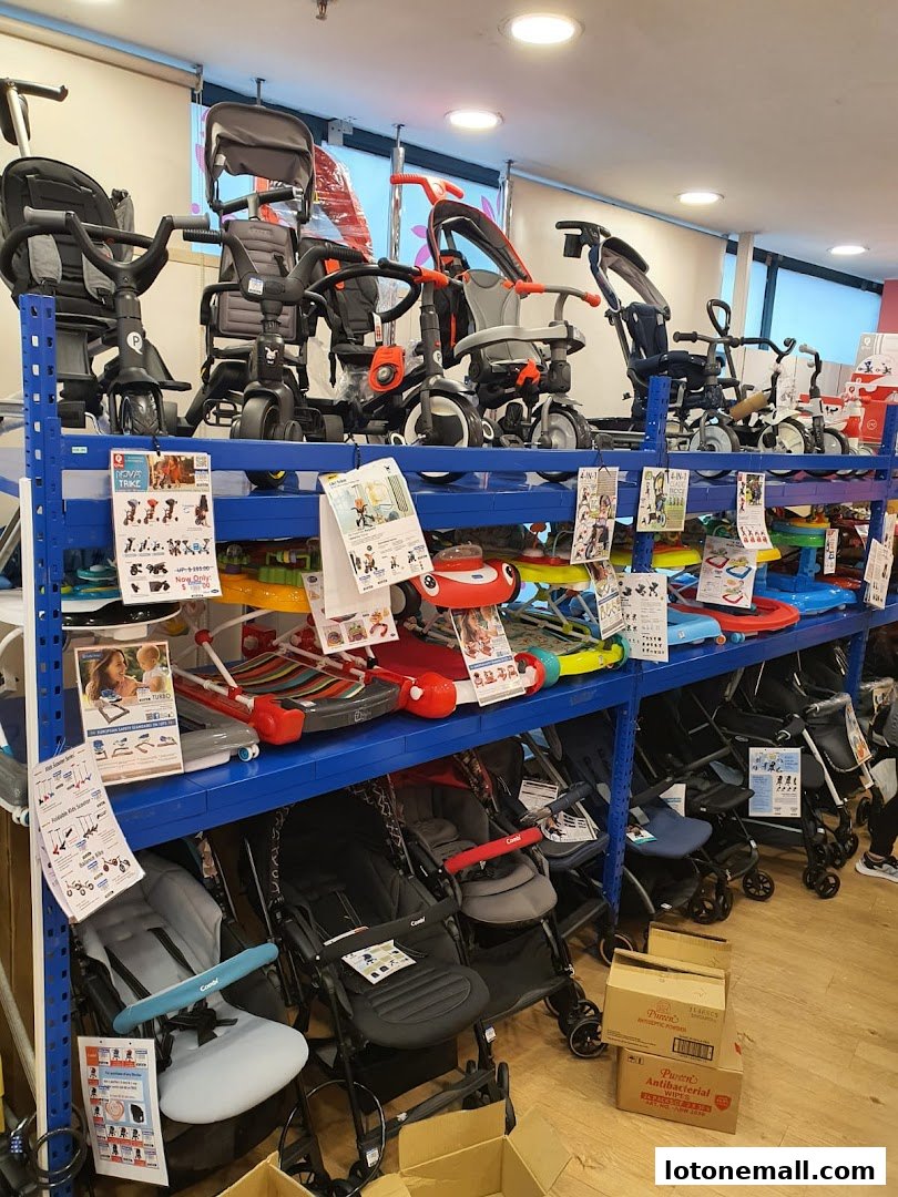 Shelves stocked with various baby strollers, tricycles, and ride-on toys.