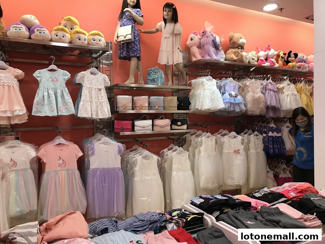 A brightly lit shop interior displaying a wide selection of children's clothing and plush toys.