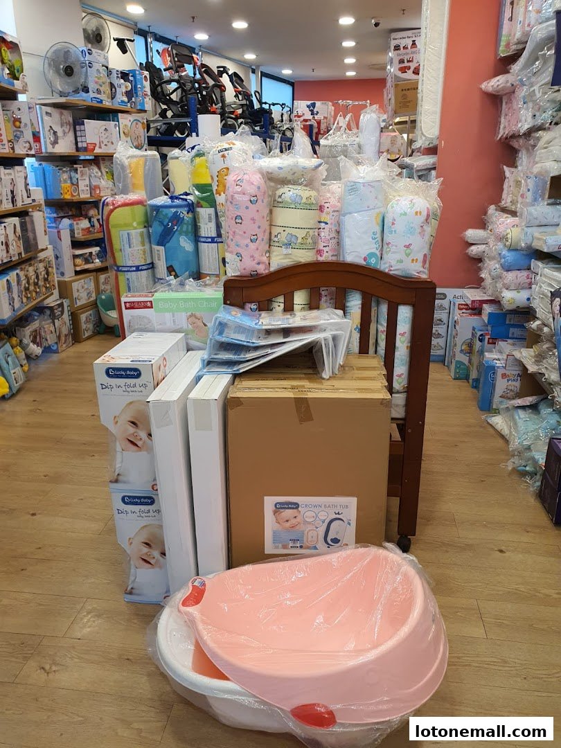 A Kiddy Palace store interior filled with baby products like cribs, strollers, bedding, and bath tubs.