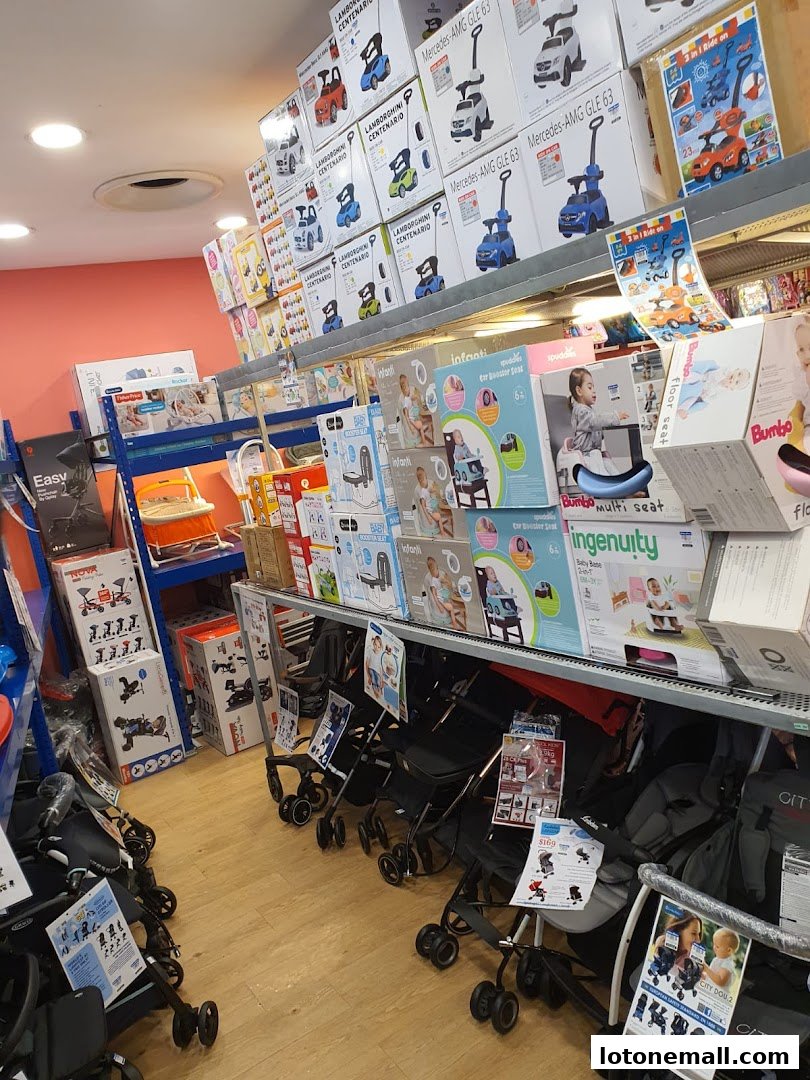 A retail store interior displaying various baby and children's products, including ride-on cars and strollers.
