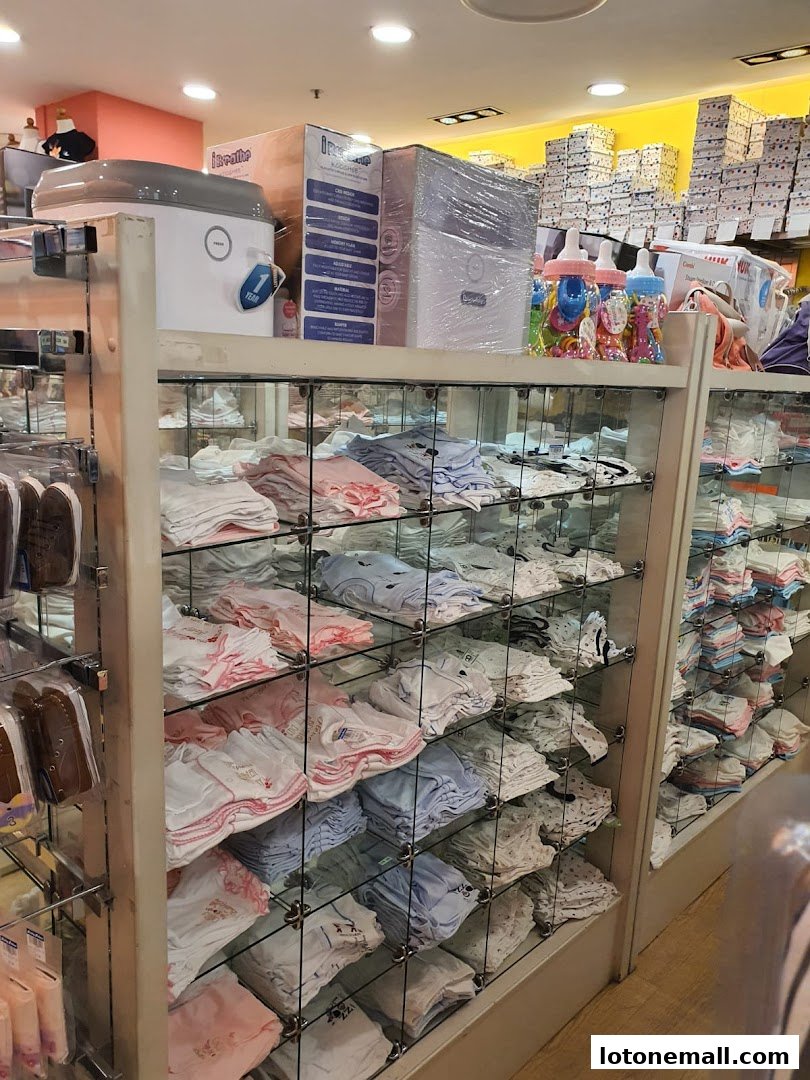 Interior view of Kiddy Palace, showcasing shelves filled with baby clothes and accessories.