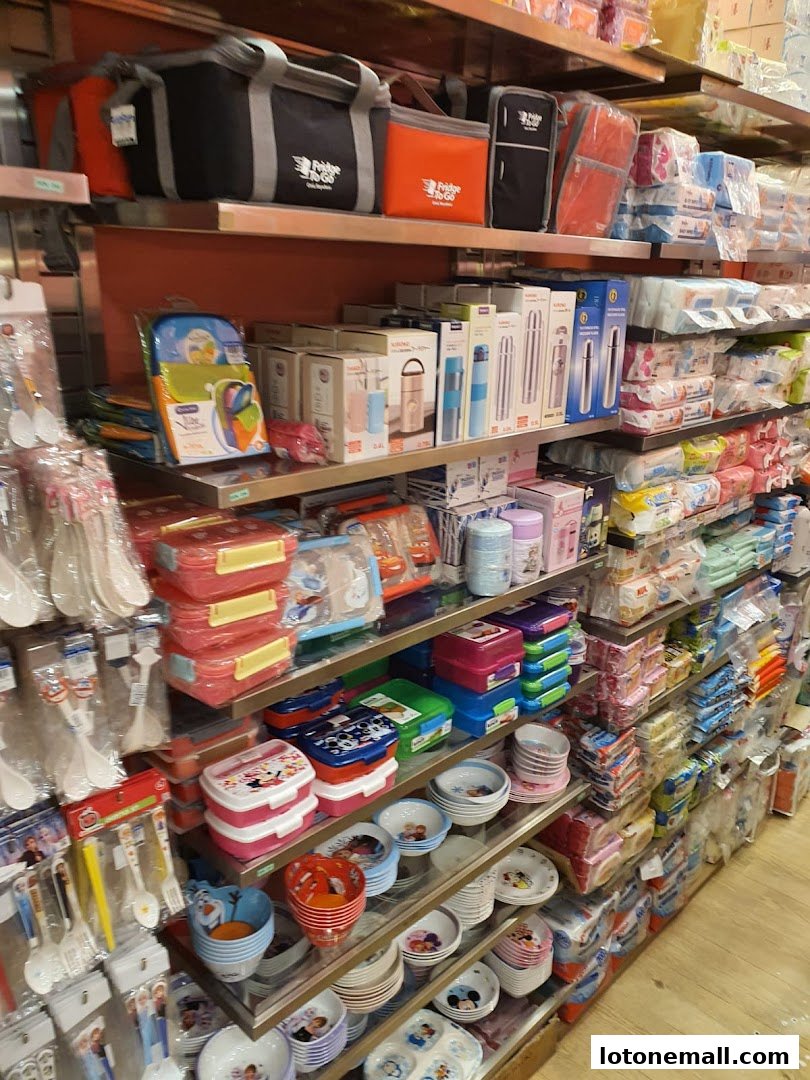 Shelves stocked with lunch boxes, thermoses, bowls, and other kitchenware for children.