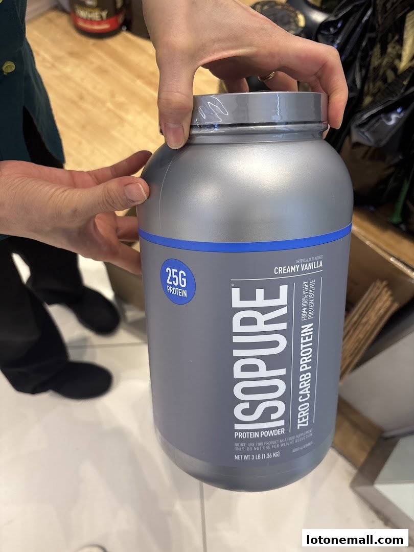 Hands holding a large tub of Isopure Zero Carb Protein powder in Creamy Vanilla flavor.