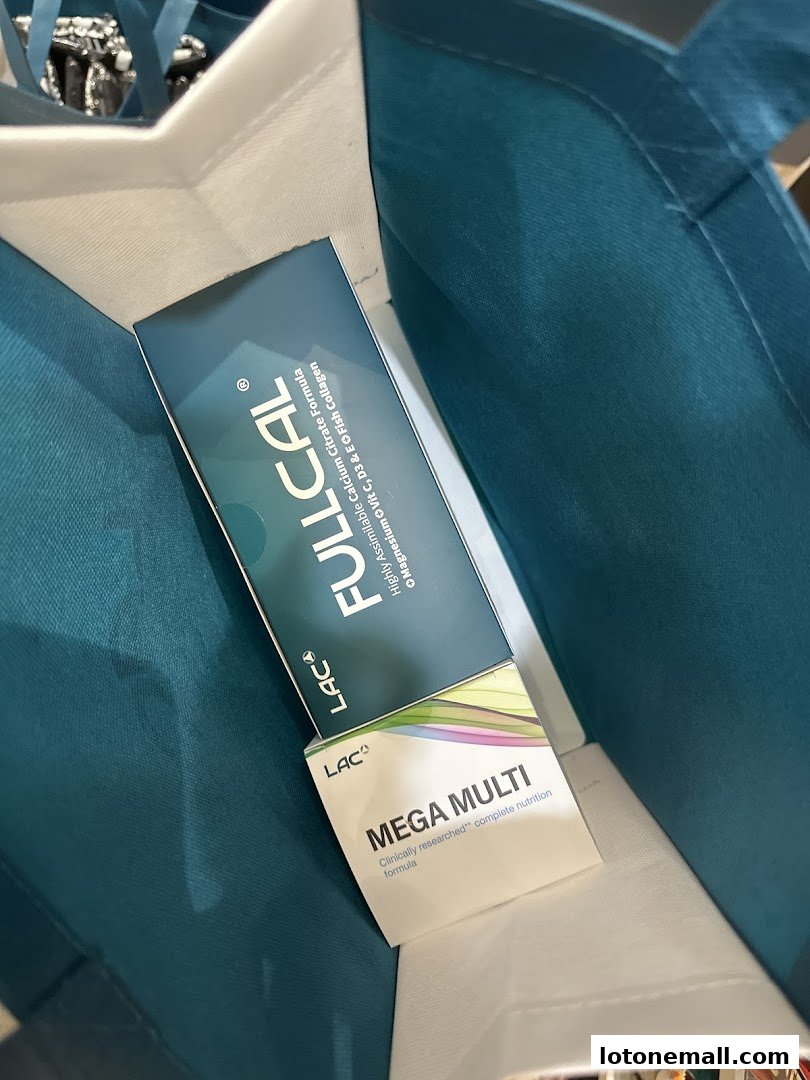 A box of LAC Mega Multi vitamins inside a teal shopping bag.
