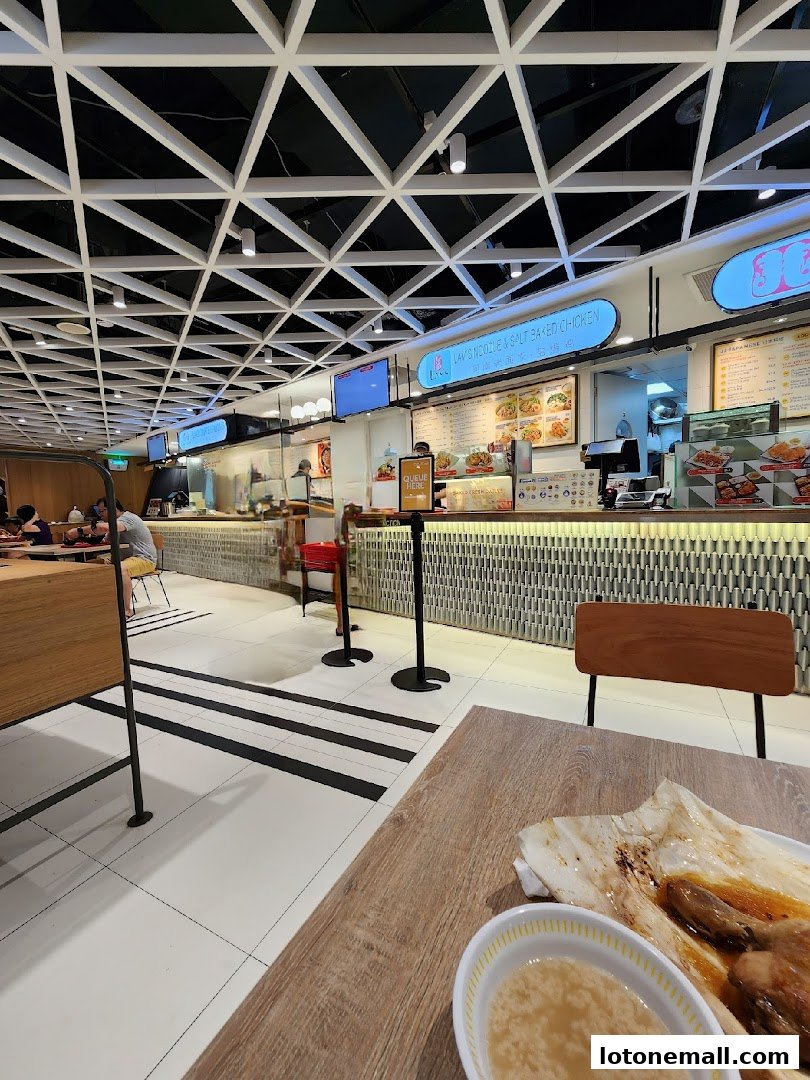 Interior view of Lams Noodle & Salt Baked Chicken with customers and food displays.