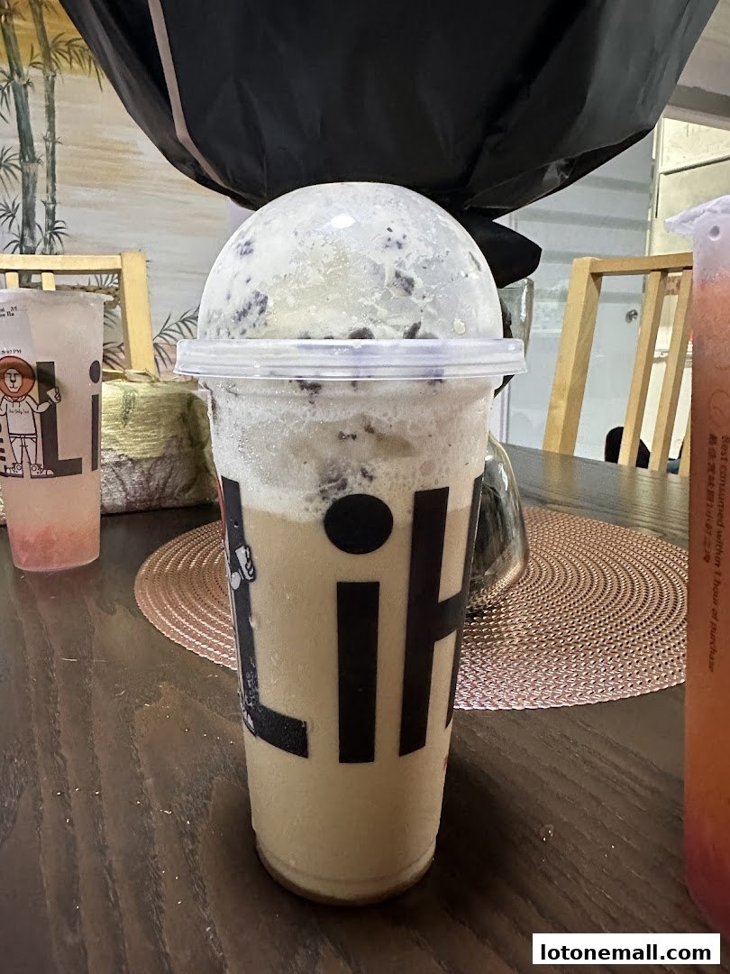 A close-up of a LiHO TEA beverage with a domed lid and crushed ice.