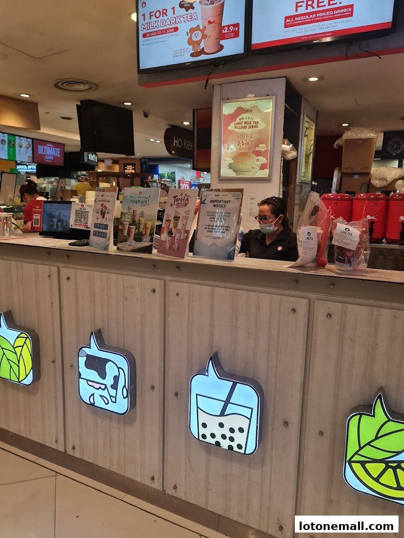 A LiHO TEA counter with promotional displays and staff serving customers.