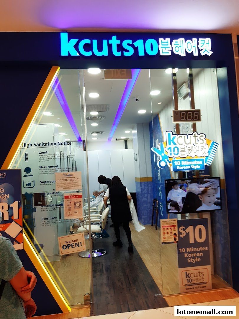 The entrance of a K-cuts hair salon with a "We are open" sign and a $10 special offer.