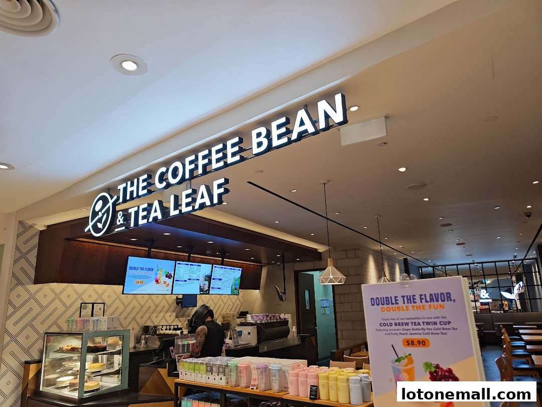 The Coffee Bean & Tea Leaf shop interior with a prominent sign and display of drinks and cakes.