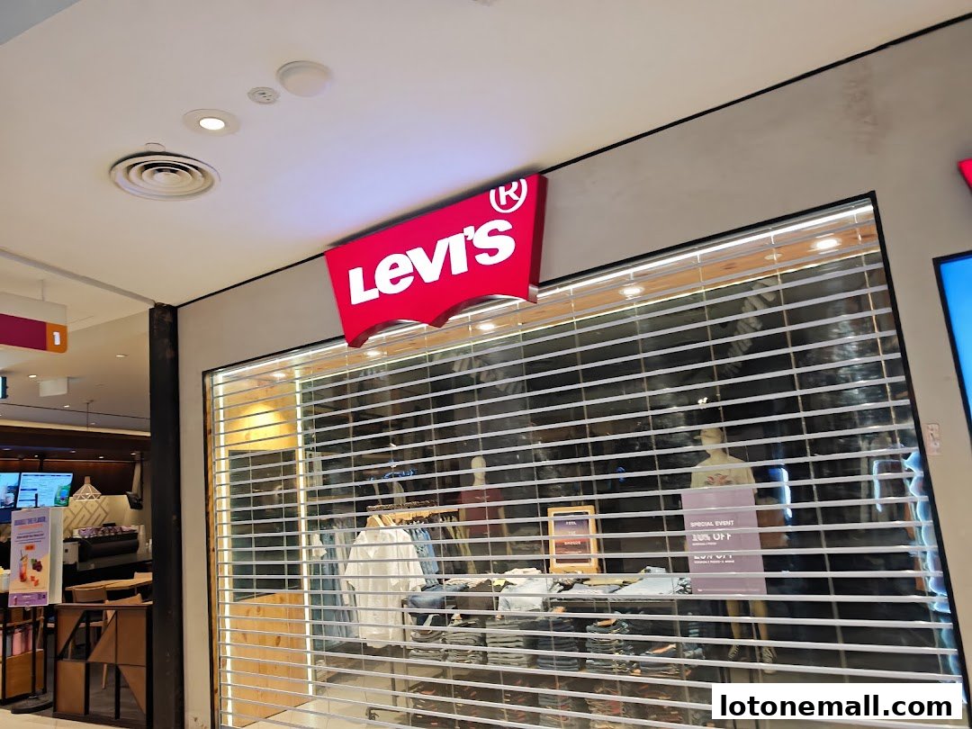 A Levi's store with its iconic logo and a closed roller shutter displaying merchandise.