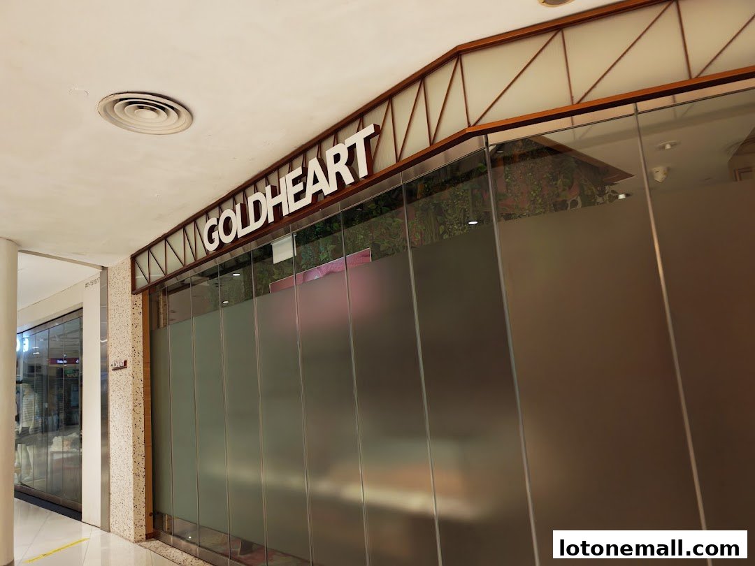 The exterior of the Goldheart jewelry store with frosted glass doors and a prominent sign.