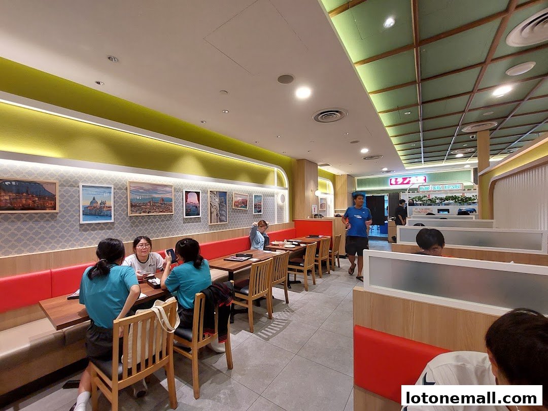 Diners seated at tables in a brightly lit restaurant with Italian-themed artwork on the walls.