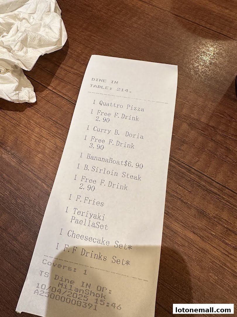 A receipt from Milan Shokudo detailing food and drink orders for table 214.
