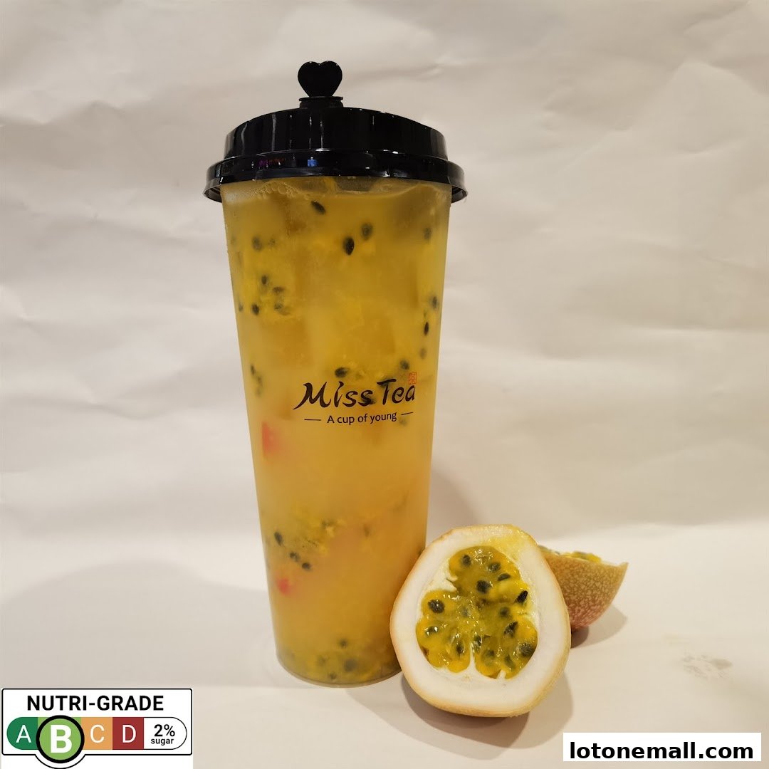 A refreshing passion fruit drink from Miss Tea with fresh passion fruit halves.