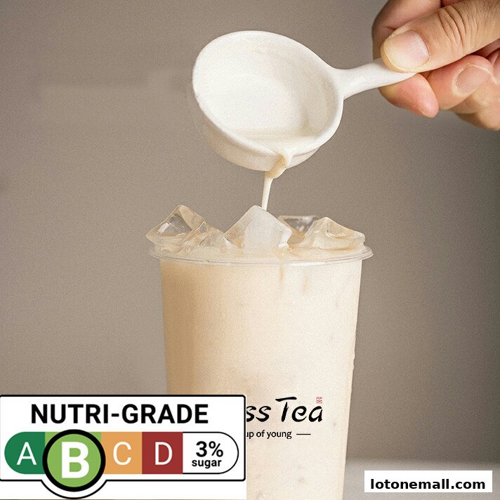 A hand pours creamy liquid into a clear cup filled with ice and a beverage.