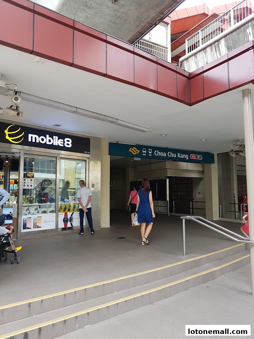 A street view of a mobile phone shop and an MRT station entrance.