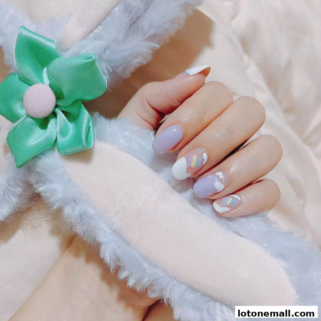 A hand with pastel purple and white nail art, featuring rainbow accents, rests on a fluffy headband.