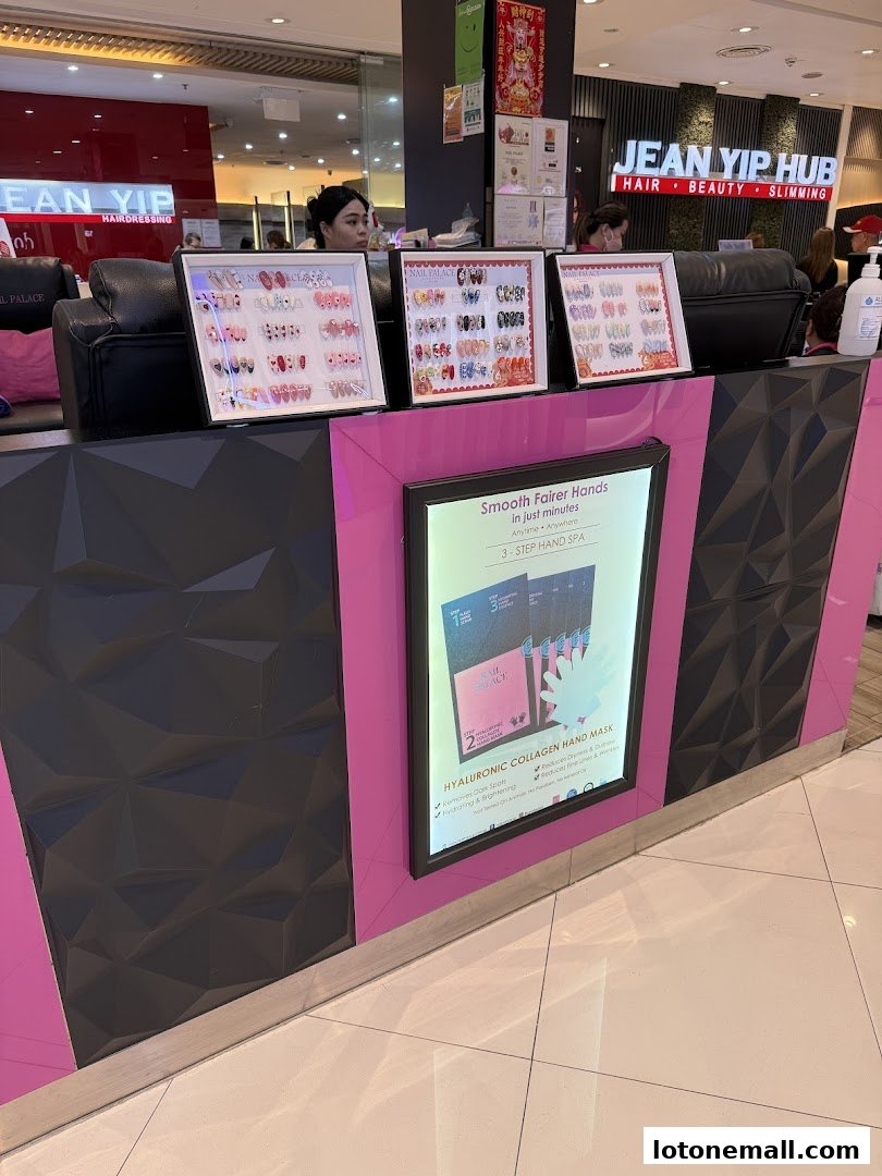 A Nail Palace counter displaying various nail art samples and a promotional poster.