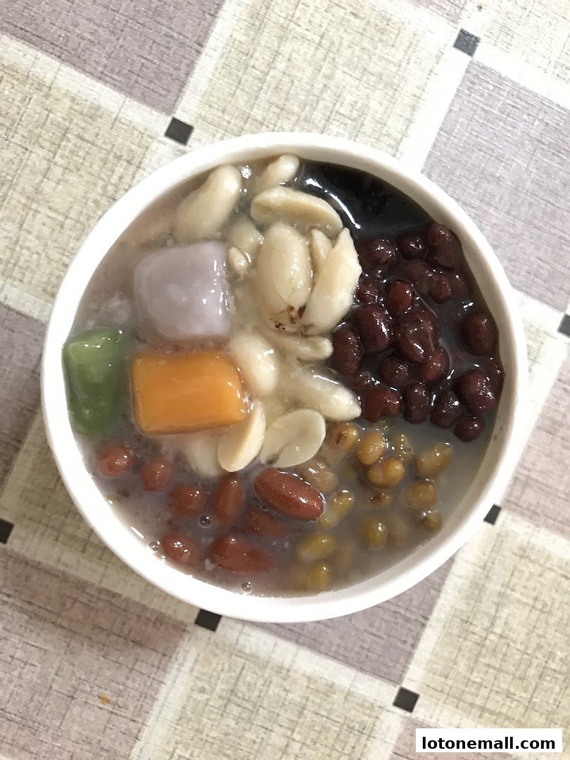 A bowl of Taiwanese dessert with various toppings including peanuts, red beans, taro, and grass jelly.