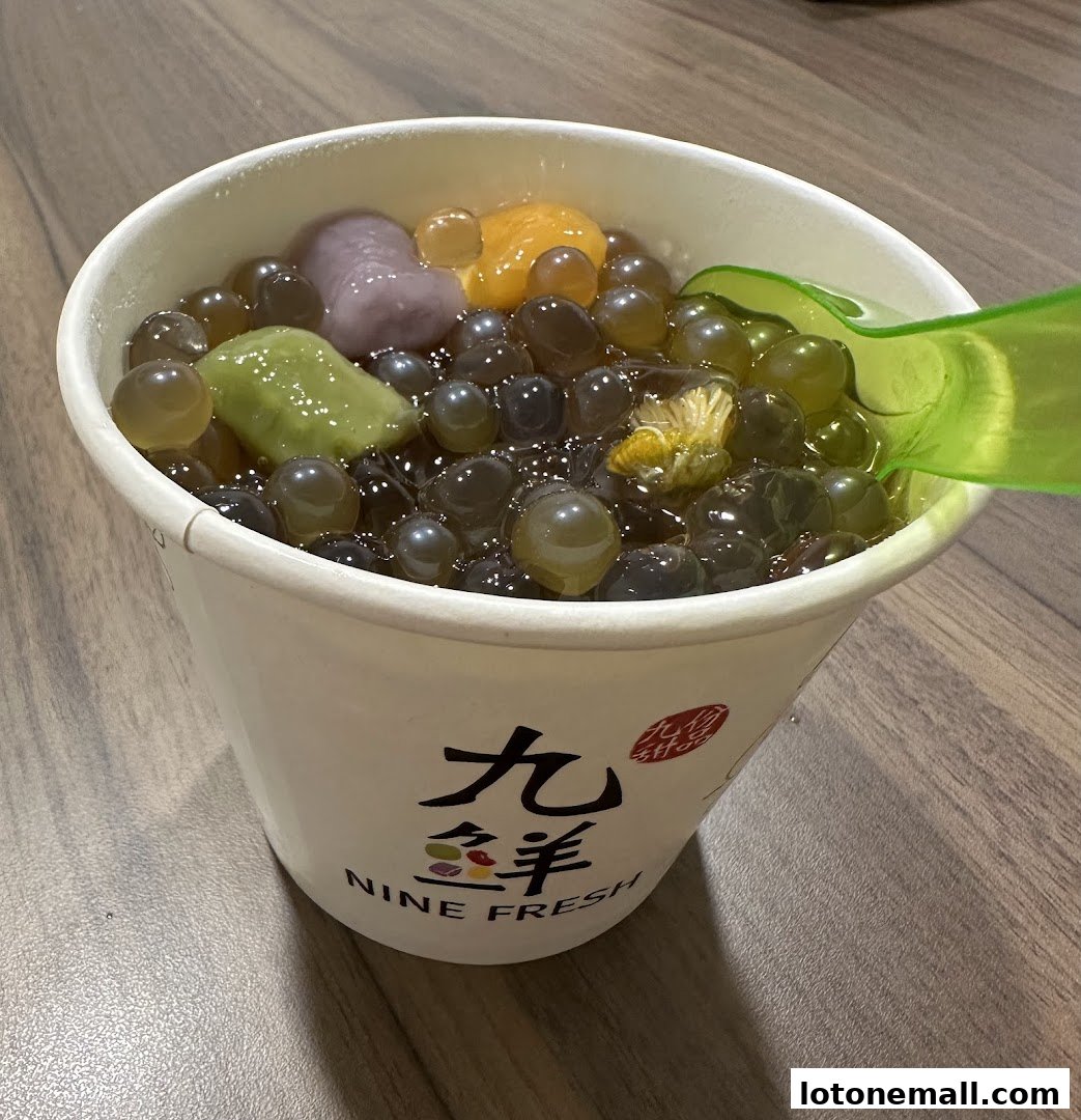 A cup of Nine Fresh Desserts with taro balls, sweet potato balls, and pearls.