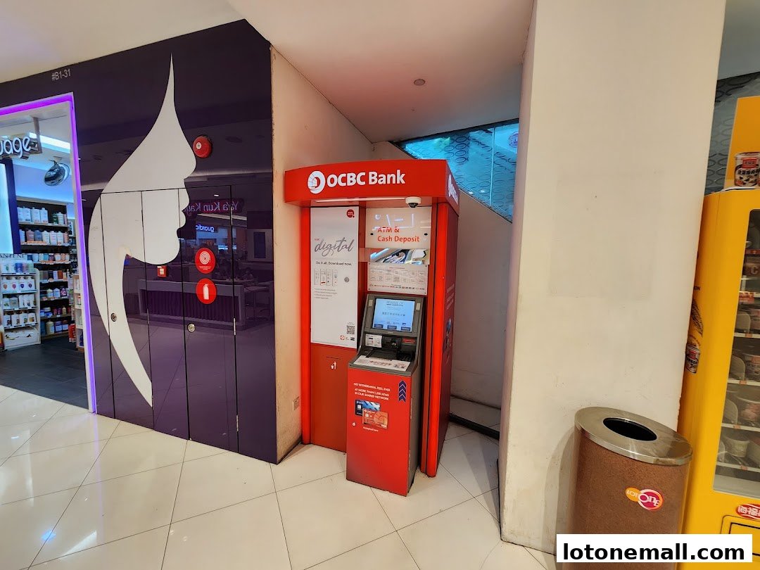 An OCBC Bank ATM is located next to a purple-fronted shop and a yellow vending machine.