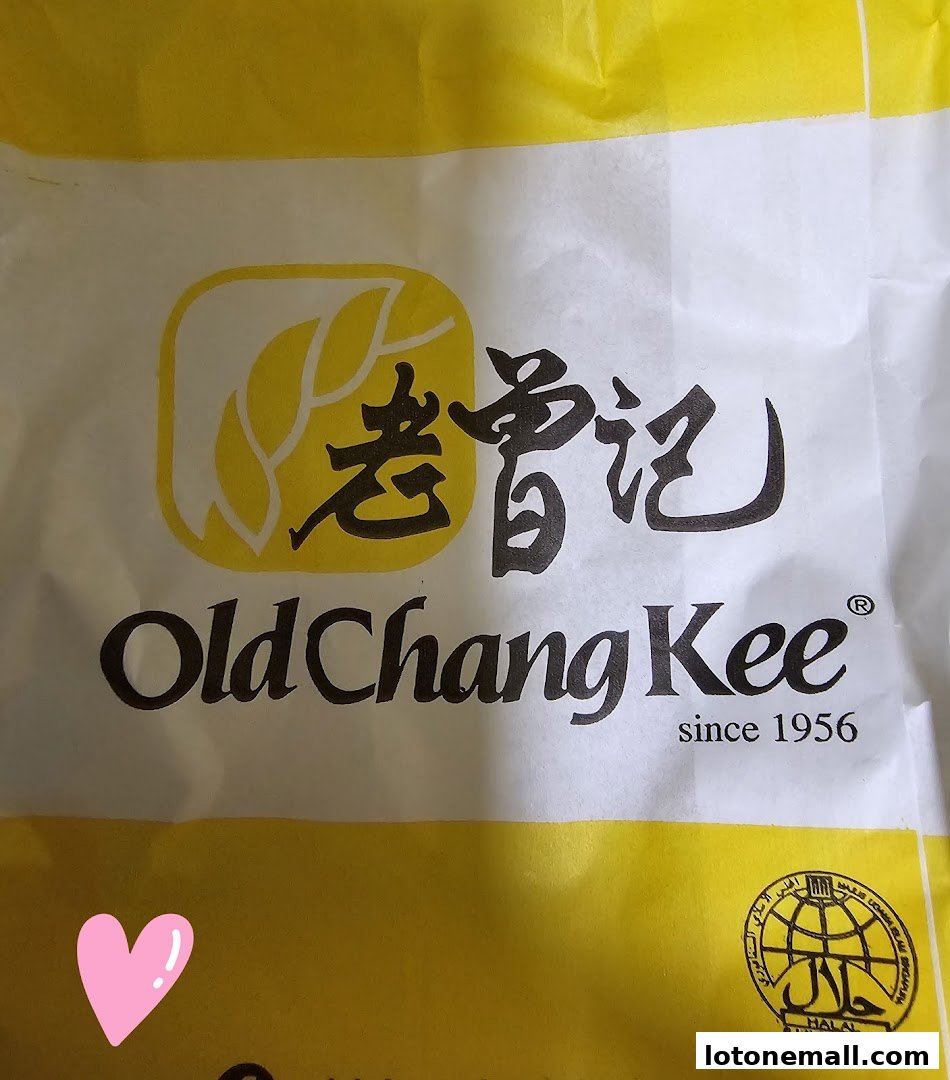 A close-up of a white and yellow paper bag with the Old Chang Kee logo and Halal certification.