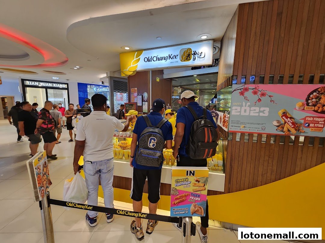 Customers queue at an Old Chang Kee stall, with promotional posters visible.