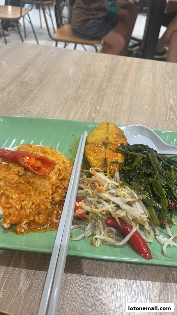 A plate of rice with curry, fried fish, and stir-fried vegetables with chili.