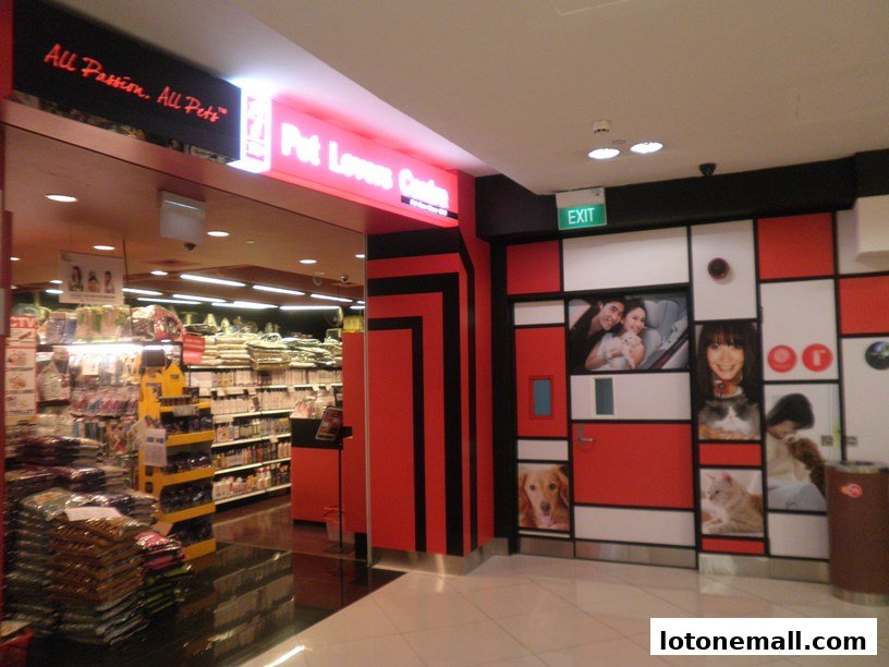 The entrance to Pet Lovers Centre, showcasing a vibrant red and white facade with pet-themed imagery.