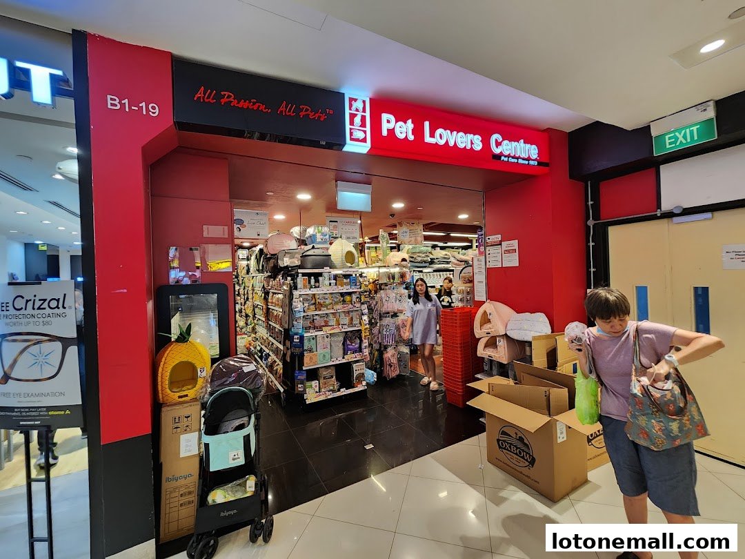 The entrance of Pet Lovers Centre shop with various pet supplies displayed inside and outside.